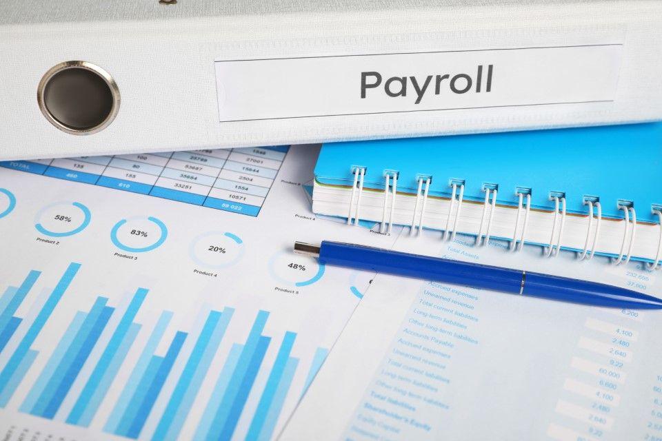 Stack of folders and documents related to payroll